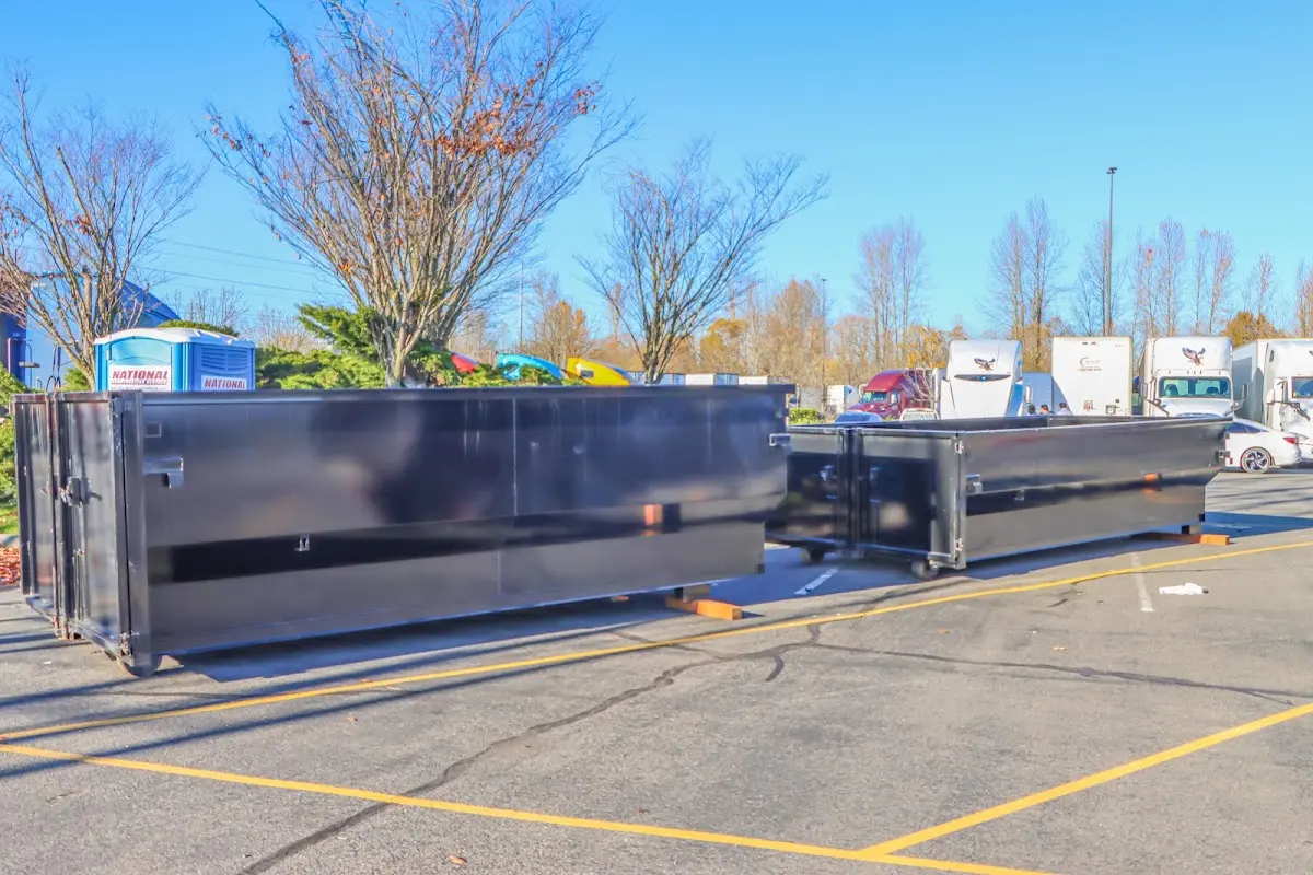 Professional dumpster rental service with roll-off container on residential driveway in Waunakee